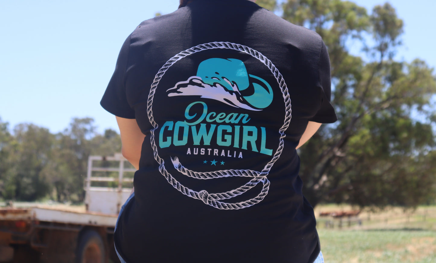 Ocean Cowgirl Black Tee - Teal Logo